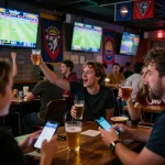 Engaged sports fans celebrating while placing bets on god55 sports at a lively bar atmosphere
